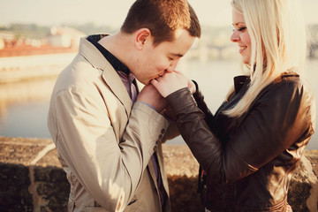 man and woman tenderly holding each other's hand