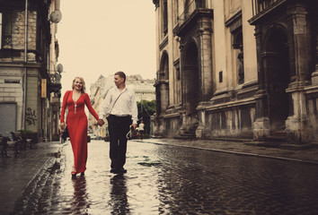 The lovely couple in love walking along street