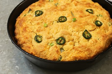Skillet Jalapeno Cornbread on dark wooden background