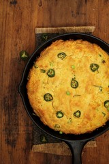 Skillet Jalapeno Cornbread on dark wooden background