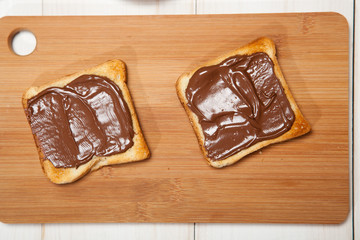 toast with chocolate on a white wooden table
