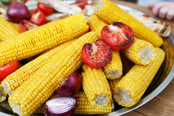 Fresh corncobs cooked at barbecue grill