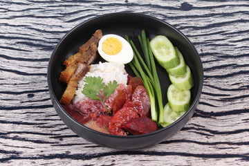 Jasmine rice with meat and boiled egg topped red sweet sauce .