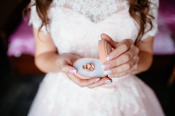 the bride holding a box with wedding rings