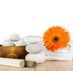 Spa concept / Spa decoration with orange Gerbera daisy, towel and spa stones