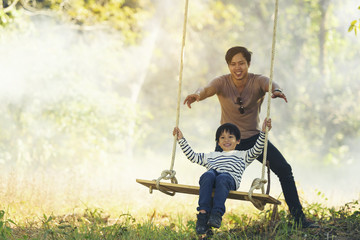 Happy asian family on a swing at field in the countryside. Smile with family on Thailand 2017 - 137089266