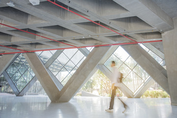 Epoxy Concrete floor. Large vertical poster on wall. Broad columns in background. Concept of...