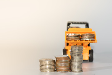 bulldozer toy and coins ,concept idea for save money and business.