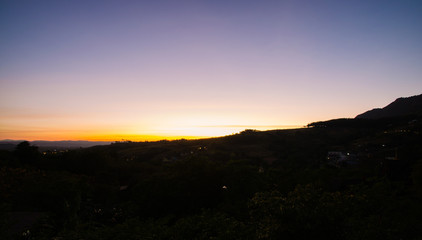 Obraz premium silhouette hills on colorful sunset.