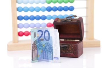 Home economy. Euros, abacus and small chest. Isolated on white background with shadow reflection.