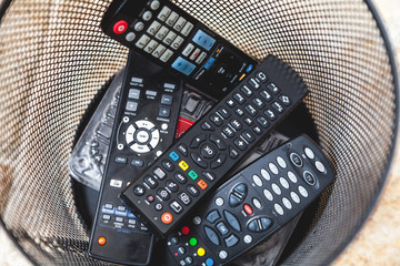 Several remote controls are in trash top view