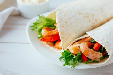 Tortilla with shrimps and salad