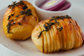 Baked potatoes with herbs closeup