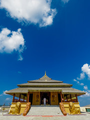 Golden Temple Palace Relic House with lion statue scluptures with blue sky and clouds at Nelligala International Buddhist Center Kandy, Sri Lanka