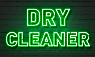 Dry cleaner neon sign on brick wall background.
