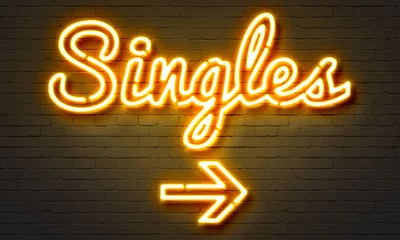 Fotobehang Singles neon sign on brick wall background. © ibreakstock