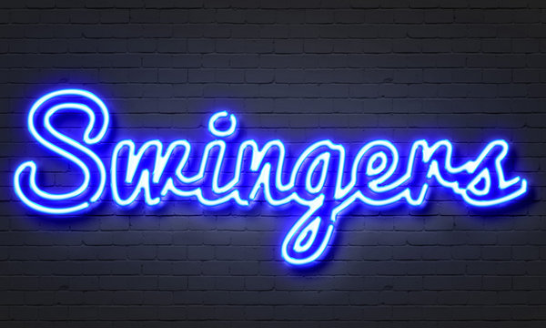 Swingers neon sign on brick wall background.