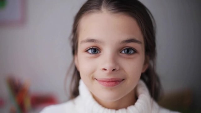 happy smiling beautiful girl in sweater at home