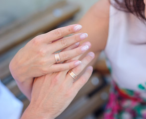 hands of bride and groom with gold rings