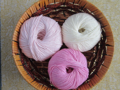 three wooden yarn in a basket