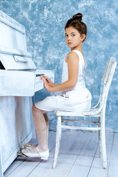 girl plays the piano
