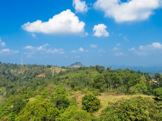 Fototapeta na wymiar Beautiful Mountain view landscape over greenery with Blue sky and white clouds in Nelligala Kandy, Sri Lanka