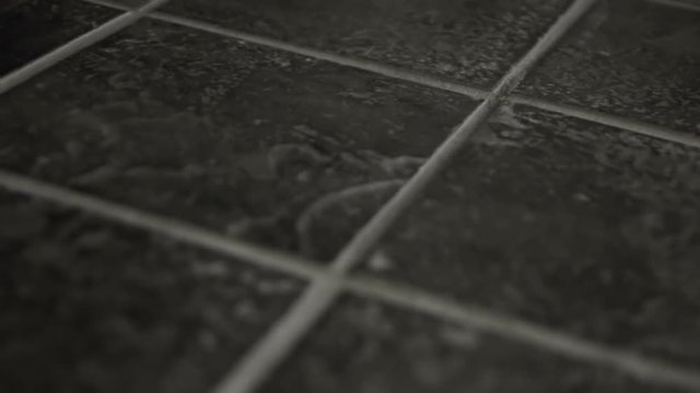 Close up dolly of grey tiles.
