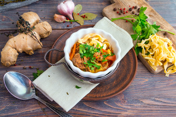 Lamian (lagman) - traditional asian noodles soup with meat, vegetables, herbs, spices and meat broth.