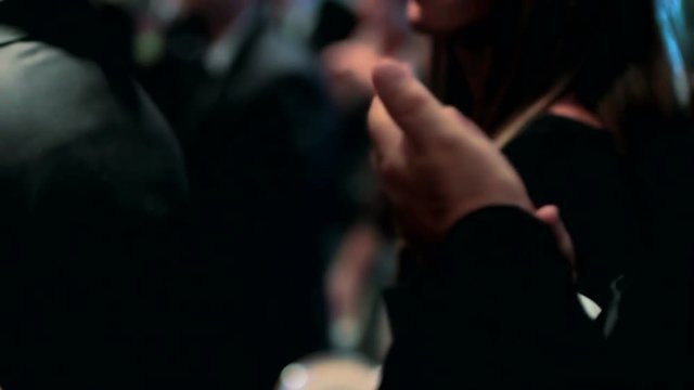 Hands clapping to the beat of a song during a party.