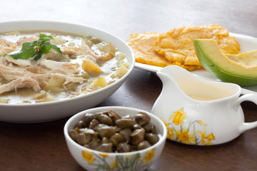 Ajiaco Preparation: Ajiaco served with patacon, avocado and capers