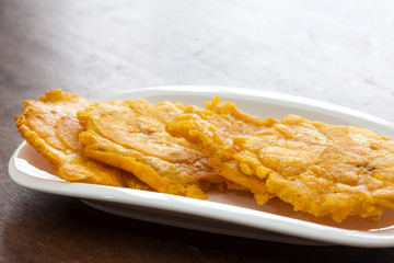 Ajiaco Preparation: Fried pieces of plantain called patacones