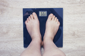 Feet on scales. Excess weight