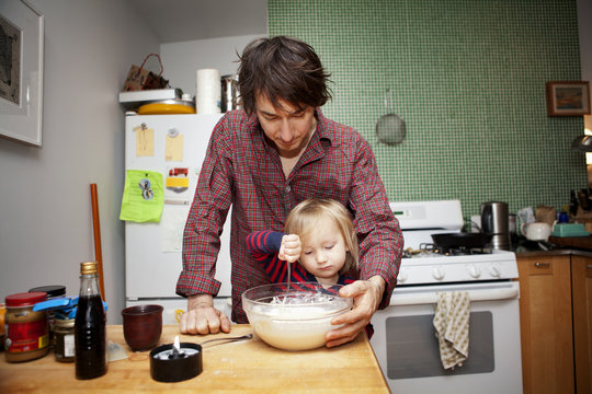 Farther and son ( 2-3 ) preparing food