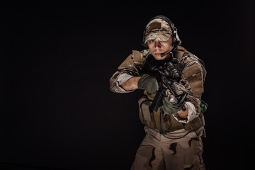 Portrait soldier or private military contractor holding sniper rifle. war, army, weapon, technology...