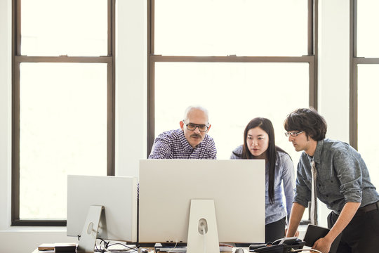 Business People Looking At Computer Screen In The Office