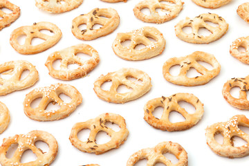 Salted crunchy handmade pastry on white background. Christmas pastry. New Year's pastry. Salted pretzels with cumin and sesame and cheese. Typical party or holiday cracknels. Typical european delicacy