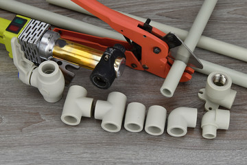 Plastic pipe welder. Components making water pipes and special scissors for cutting plastic water pipes.