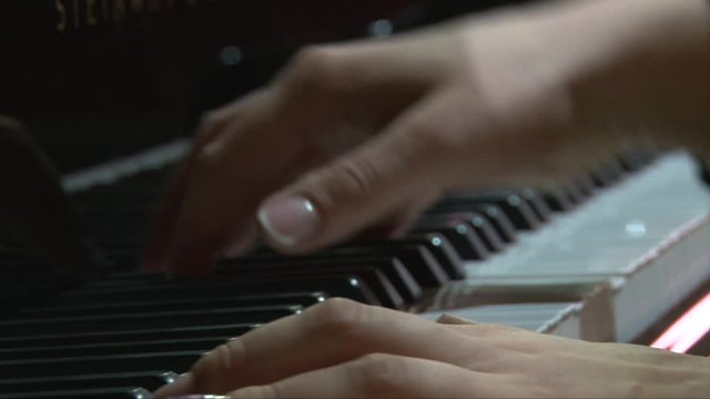 Female hands quickly playing piano, dolly shot go straight and back, close up, perfect for titles