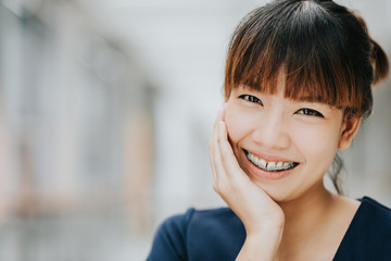 Portrait of happy young pretty Asian girl with braces smiling.
