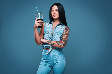 Beautiful charming tattoo girl with soda