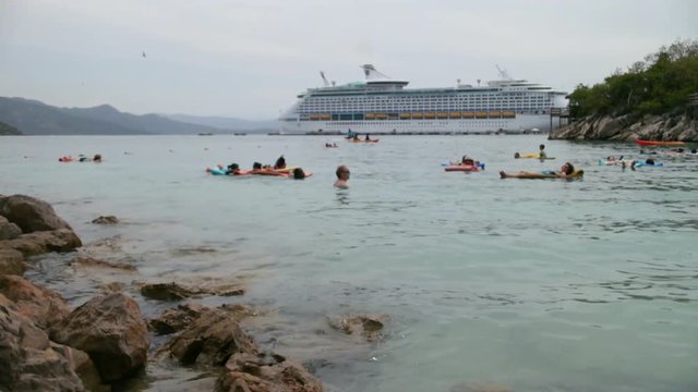 LABADEE, HAITI- AUGUST 31: Royal Caribbean cruise ship Explorer of the Seas docked at the private port of Labadee in the Caribbean Island of Haiti on August 31, 2013. Tourists enjoy day of relaxation.