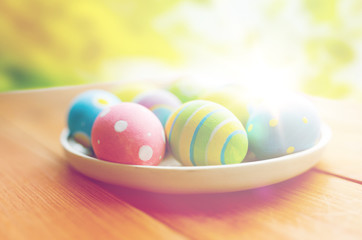 close up of colored easter eggs on plate