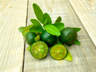 Calamansi isolated on wooden background