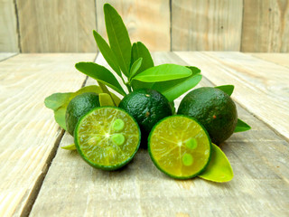 Calamansi isolated on wooden background