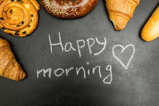 Fresh baked goods on a black background, the words "good morning"