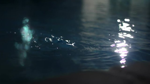 Water running in a dark pool at night.