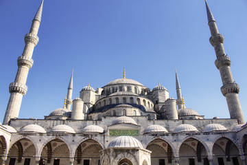 Fototapeta na wymiar Bottom view of Blue (Sultanahmet) Mosque with blue clear sky in the background in Istanbul. Well-known site built in 1616 & containing its founder's tomb.