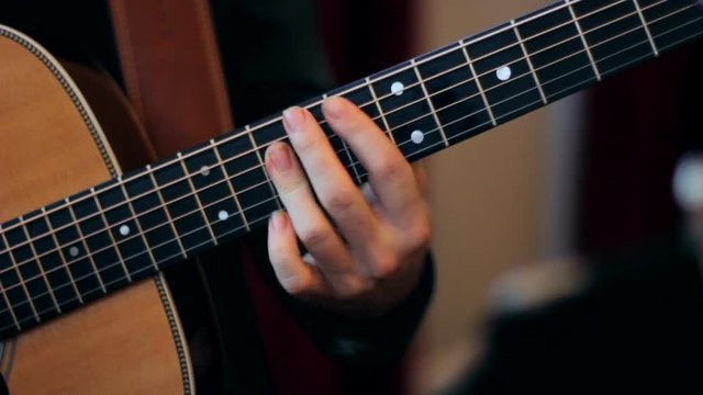 Close up of man playing an acoustic guitar. 
