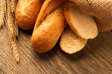 French baguette sliced on the wooden desk