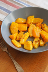 Cooked pieces of pumpkin vegetable in gray plate 